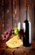 Red wine with cheese on a wooden background