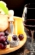 Red wine with wine grapes cheese plate and bread