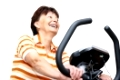 Senior woman exercise on spinning bicycle at home