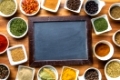 Blank chalkboard and various spices. Top view.