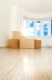 Heap of boxes in an empty living room against a window