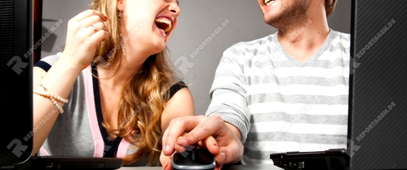 man is holding female hand over mouse