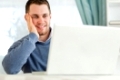 Young smiling man on his laptop