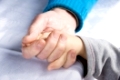 senio holding the hand of a young child