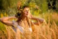 happy young woman in a wreath from a grass
