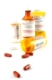 Pills and vials on white background
