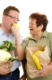 Frau lässt ihren Ehemann von einem Apfel abbeißen