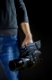 Kiev, Ukraine - April 22, 2018: Cameraman holding his professional camcorder Panasonic AU-EVA1 in the studio. Operator in social environment, filming, news outlet, motion-picture cameraman