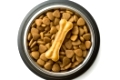 Dog chew bone and dry kibble dog food in bowl isolated on white background.