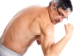Senior man posing and showing his biceps, isolated on white background.