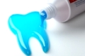 Toothpaste in the shape of tooth coming out from toothpaste tube. Brushing teeth dental concept. 3d illustration