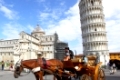 PISA, ITALY - September 03, 2014: Tourist carriage near Cathedral and the Leaning tower in Pisa