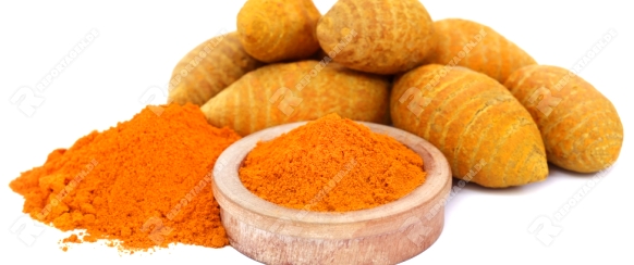 Whole and ground turmeric in bowl, over white background
