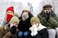 Group of diverse young friends blowing noses outdoors in winter