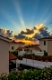 Sunset with sunbeams over luxurious holiday beach villas for rent on Cyprus
