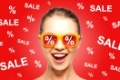people, summer, shopping and sale concept - happy screaming teenage girl in shades over red background with percentage signs