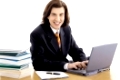 long haired man in suit on white with laptop and books