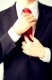close up of man adjusting his tie