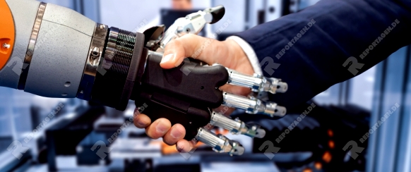 Hand of a businessman shaking hands with a Android robot. The concept of human interaction with artificial intelligence.