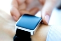 business, technology and people concept - close up of woman hands setting smart watch