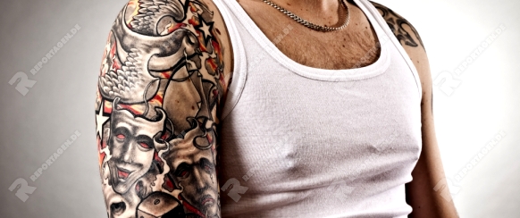 An image of a handsome man with tattoos