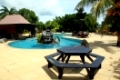 Table, pool and palm tree in the inner yard of hotel in Savaii island, Samoa