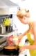 Young Woman Cooking Healthy Mediterranean Pasta with tuna fish. Fast, easy and delicious recipe.