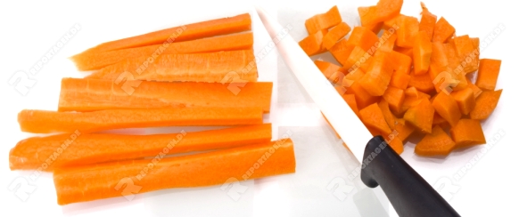 sliced carrots and a knife on a chopping board