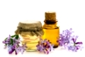 Bottles of natural essential oil from lilac flowers on a white background. Macro Selective focus. Space for text