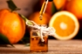 Bottle of essential oil from oranges on wooden background - alternative medicine