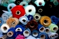 multicolored rolls of fabric at a flea market